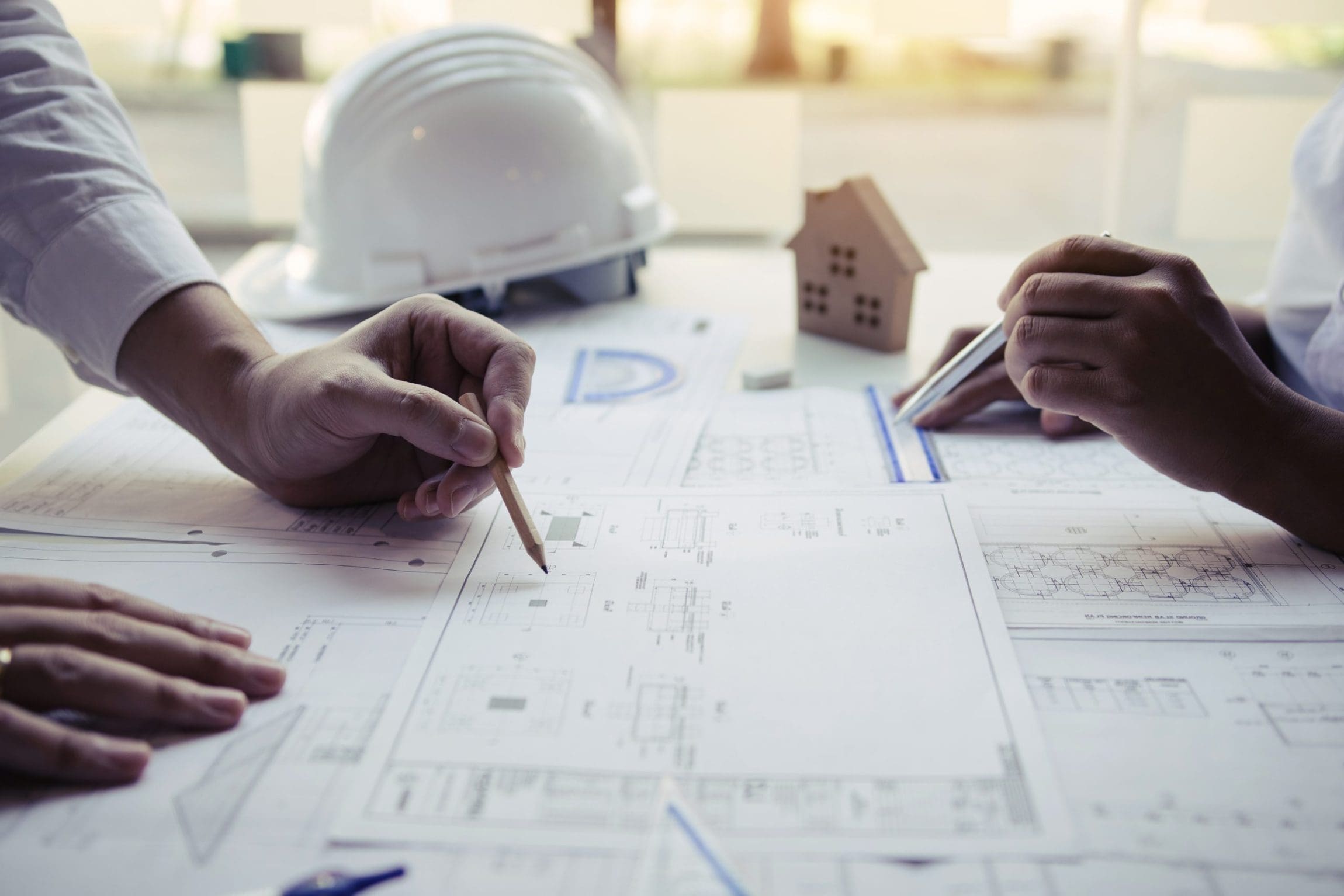 Engineers are helping to design work on blueprints and collaborate on structural analyzing of project types.